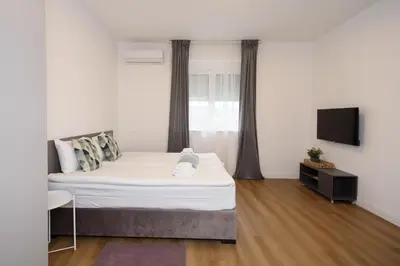 a bedroom with a bed and a flat screen tv at Top Central 6 Apartments in Belgrade