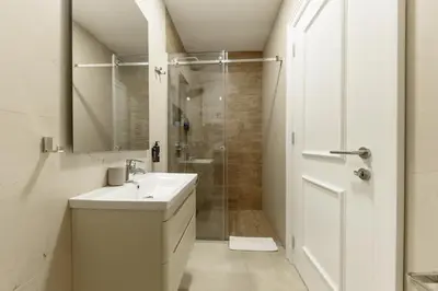 a white bathroom with a sink and a shower at Top Central 6 Apartments in Belgrade