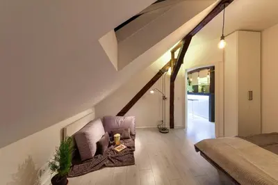 a living room with a chair and a bed at City Centre Rooftop Knez Mihailova Apartment in Belgrade