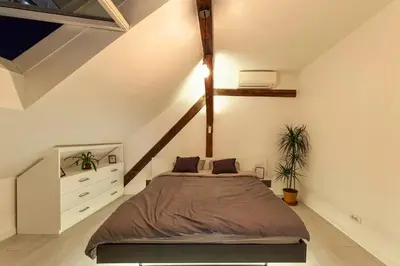 a bedroom with a bed in a attic at City Centre Rooftop Knez Mihailova Apartment in Belgrade