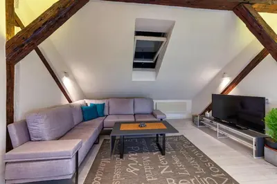 a living room with a couch and a tv at City Centre Rooftop Knez Mihailova Apartment in Belgrade