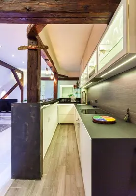 a kitchen with white cabinets and a green counter top at City Centre Rooftop Knez Mihailova Apartment in Belgrade