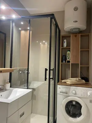 a bathroom with a washing machine and a washer at Apartman Silver Bg in Kneževac