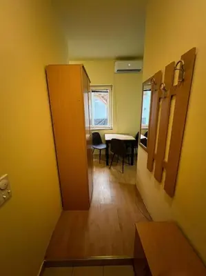 a hallway of a room with a table and chairs at TripleA Sr apartments in Belgrade
