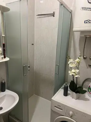 a bathroom with a shower with a toilet and a sink at TripleA Sr apartments in Belgrade