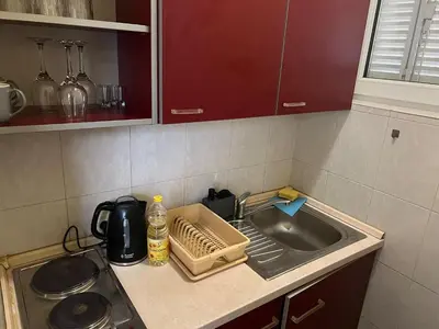 a kitchen counter with a sink and a microwave at TripleA Sr apartments in Belgrade