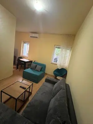 a living room with a couch and a table at TripleA Sr apartments in Belgrade