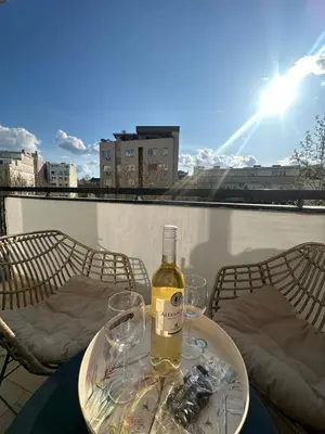 a bottle of wine sitting on a table with two glasses at Nadja City Center in Belgrade