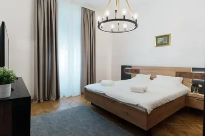 a bedroom with a bed and a chandelier at BD Old Town Suite - Pedestrian Zone - City Center in Belgrade
