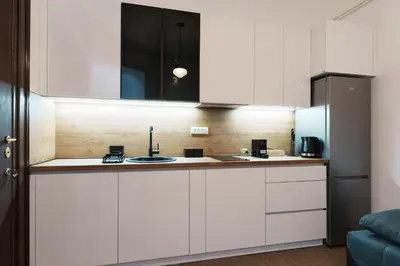 a kitchen with white cabinets and a sink at BD Old Town Suite - Pedestrian Zone - City Center in Belgrade