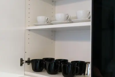 a row of black cups and saucers on a shelf at BD Old Town Suite - Pedestrian Zone - City Center in Belgrade
