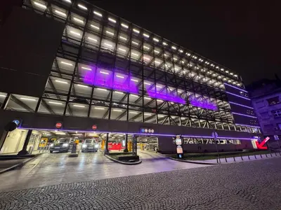 a large building with purple lights on it at night at BD Old Town Suite - Pedestrian Zone - City Center in Belgrade