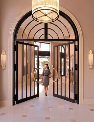 a woman walking through a door in a building at The Bristol Belgrade in Belgrade