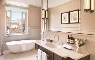 a bathroom with a large tub and a sink at The Bristol Belgrade in Belgrade