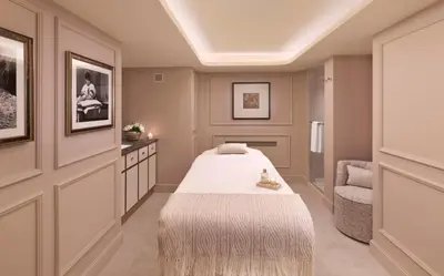 a bedroom with a bed and a chair at The Bristol Belgrade in Belgrade