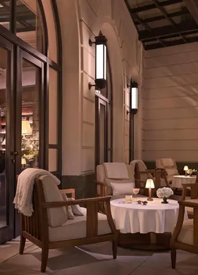 a room with chairs and a table with a table at The Bristol Belgrade in Belgrade