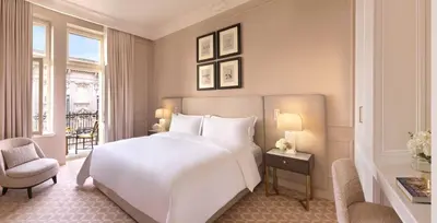 a bedroom with a large white bed and a window at The Bristol Belgrade in Belgrade