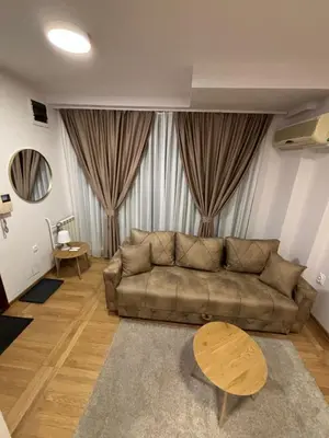 a living room with a couch and a table at Lux Vracar by Magenta in Belgrade