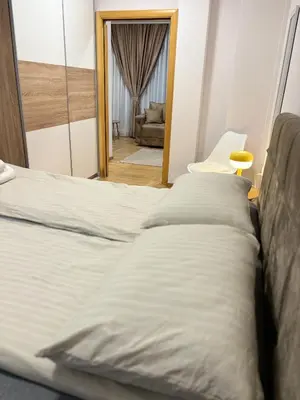 a row of beds in a room with a mirror at Lux Vracar by Magenta in Belgrade