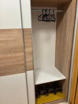 a cupboard with five wine bottles in it at Lux Vracar by Magenta in Belgrade