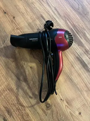a black hair dryer on a wooden table at R&B apartments in Belgrade