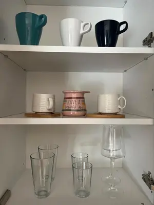 a shelf with cups and glasses on it at R&B apartments in Belgrade