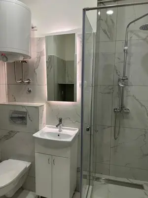 a bathroom with a sink and a glass shower at City Centre Retreat Palmoticeva Studio in Belgrade