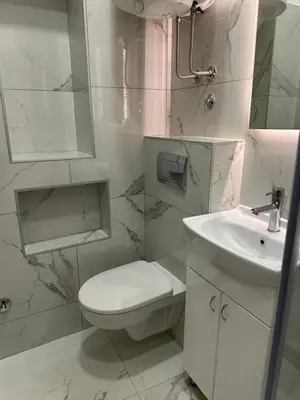 a white bathroom with a toilet and a sink at City Centre Retreat Palmoticeva Studio in Belgrade