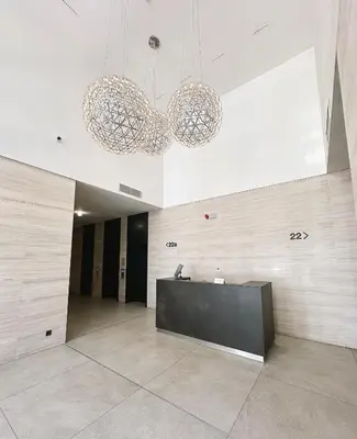 a lobby with two chandeliers and a reception desk at SARA Lux A Blok in Belgrade