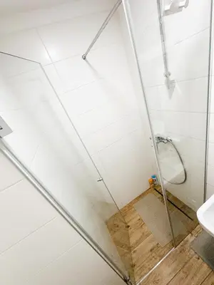 a shower with a glass door in a bathroom at SARA Lux A Blok in Belgrade