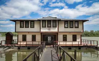 a house on a dock in the water at Guesthouse Perunov Konak in Belgrade
