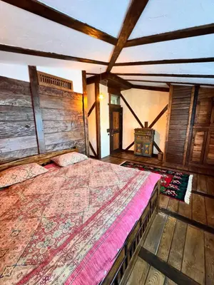 a bedroom with a large bed in a room at Guesthouse Perunov Konak in Belgrade