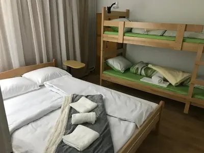 a bedroom with two bunk beds with towels at Family escape apartment free parking in Belgrade