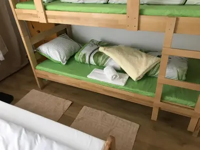 a wooden bunk bed with pillows and towels on it at Family escape apartment free parking in Belgrade