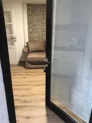 an open door with a couch in a living room at Family escape apartment free parking in Belgrade