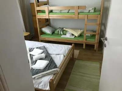 a room with two bunk beds with towels at Family escape apartment free parking in Belgrade