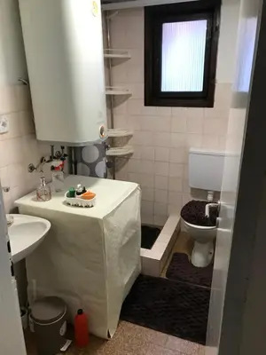 a small bathroom with a sink and a toilet at Family escape apartment free parking in Belgrade