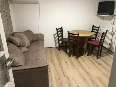 a living room with a couch and a table at Family escape apartment free parking in Belgrade