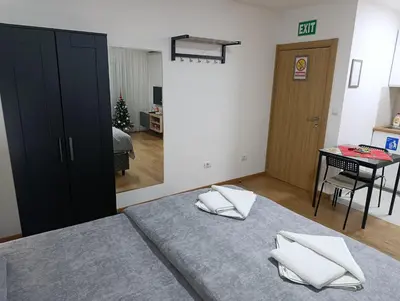 a bedroom with a bed with two pillows on it at Apartman Good Night in Surčin