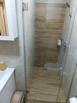 a bathroom with a shower with a toilet at Apartman Good Night in Surčin