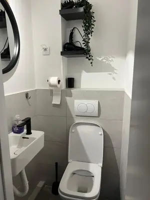 a small bathroom with a toilet and a sink at Oasis Residences A in Belgrade