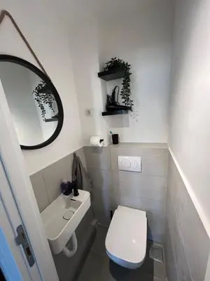 a bathroom with a toilet and a sink and a mirror at Oasis Residences A in Belgrade