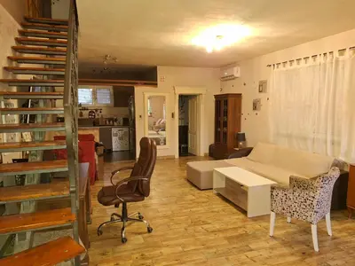 a living room with a staircase and a desk at Vila Tara in Belgrade