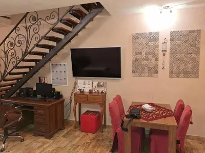 a room with a table and a desk and a staircase at Vila Tara in Belgrade