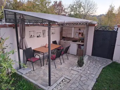 a patio with a table and chairs under a pergola at Vila Tara in Belgrade