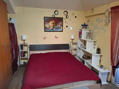 a bedroom with a bed with a red blanket at Vila Tara in Belgrade