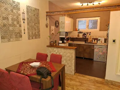 a living room with a table and a kitchen at Vila Tara in Belgrade