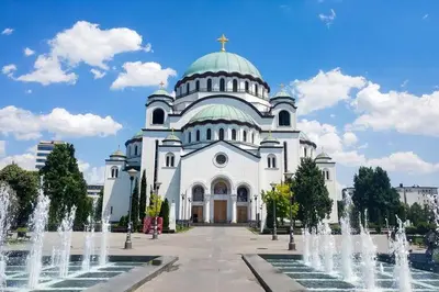 a large white church with a cross on top of it at Best choice Hram centar in Belgrade