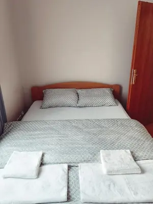 a bedroom with a bed with two pillows on it at Apartman Đul in Mladenovac