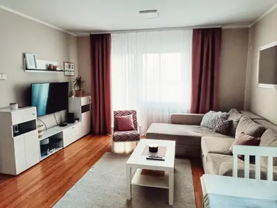 a living room with a couch and a tv at Apartman Đul in Mladenovac
